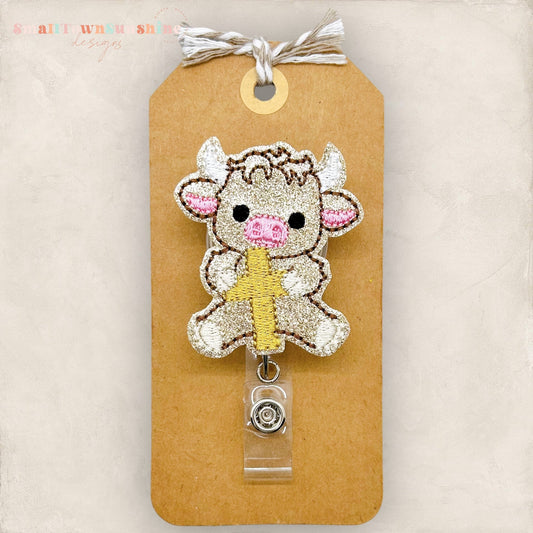 Highland Cow Holding Cross Badge Topper