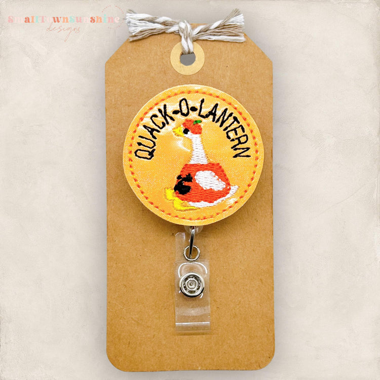 quack o lantern, duck dressed as halloween pumpkin badge reel