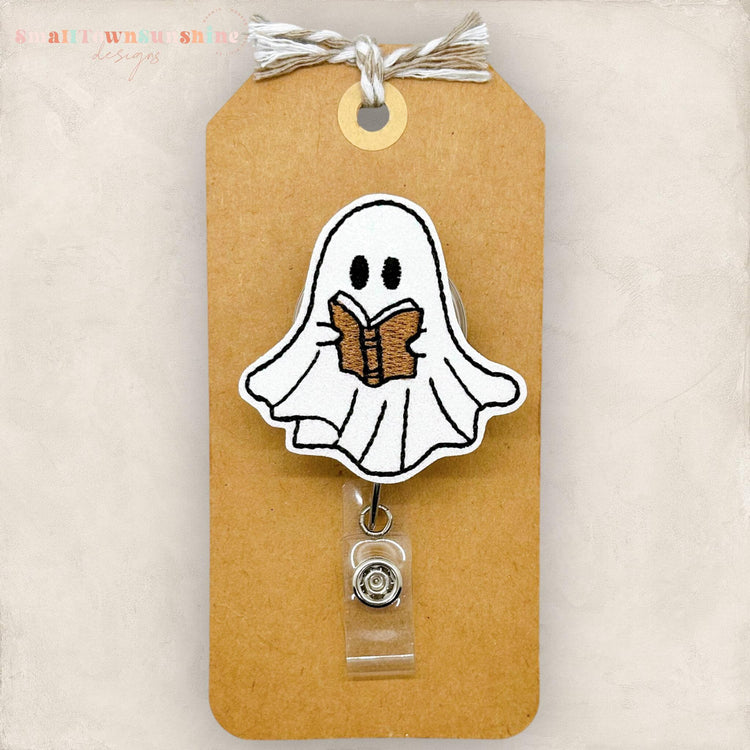 cute ghost reading a brown book embroidered badge reel