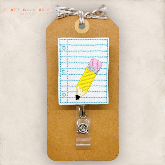 lined paper with pencil embroidered badge reel