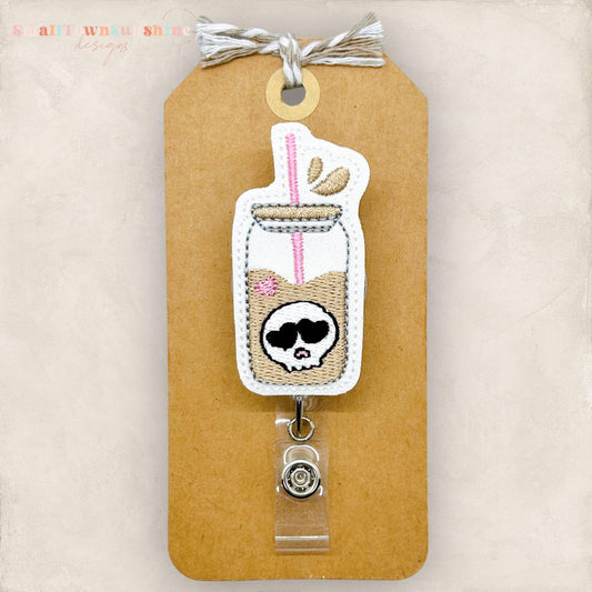 embroidered glass can with skull badge reel topper