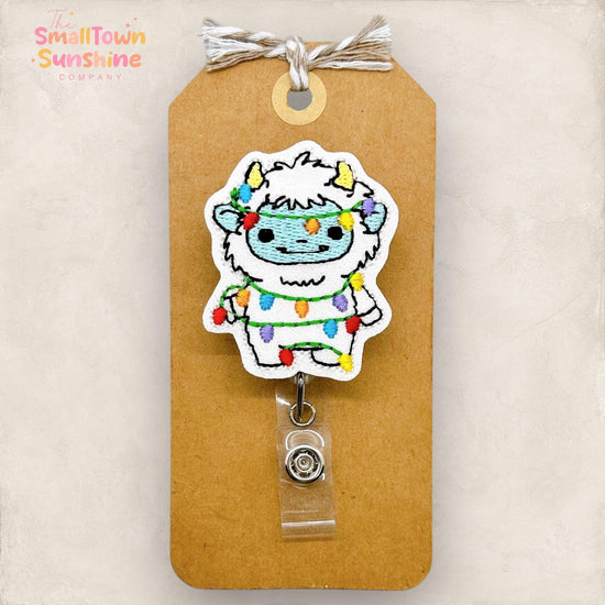 abominable snowman wrapped in christmas lights badge reel topper