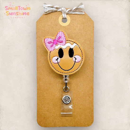 gingerbread girl face with pink bow badge reel topper